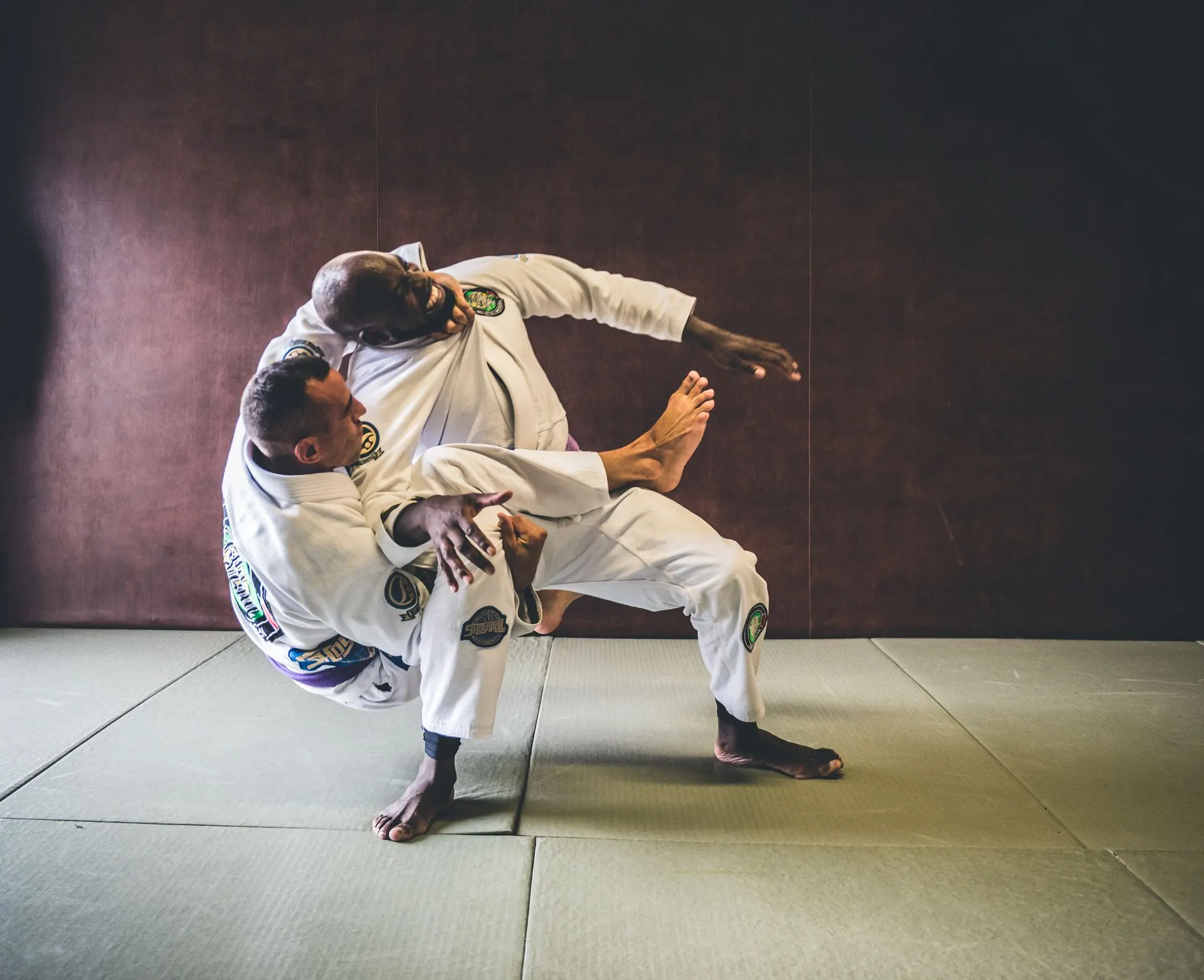 Un pratiquant en kimono blanc en pleine projection